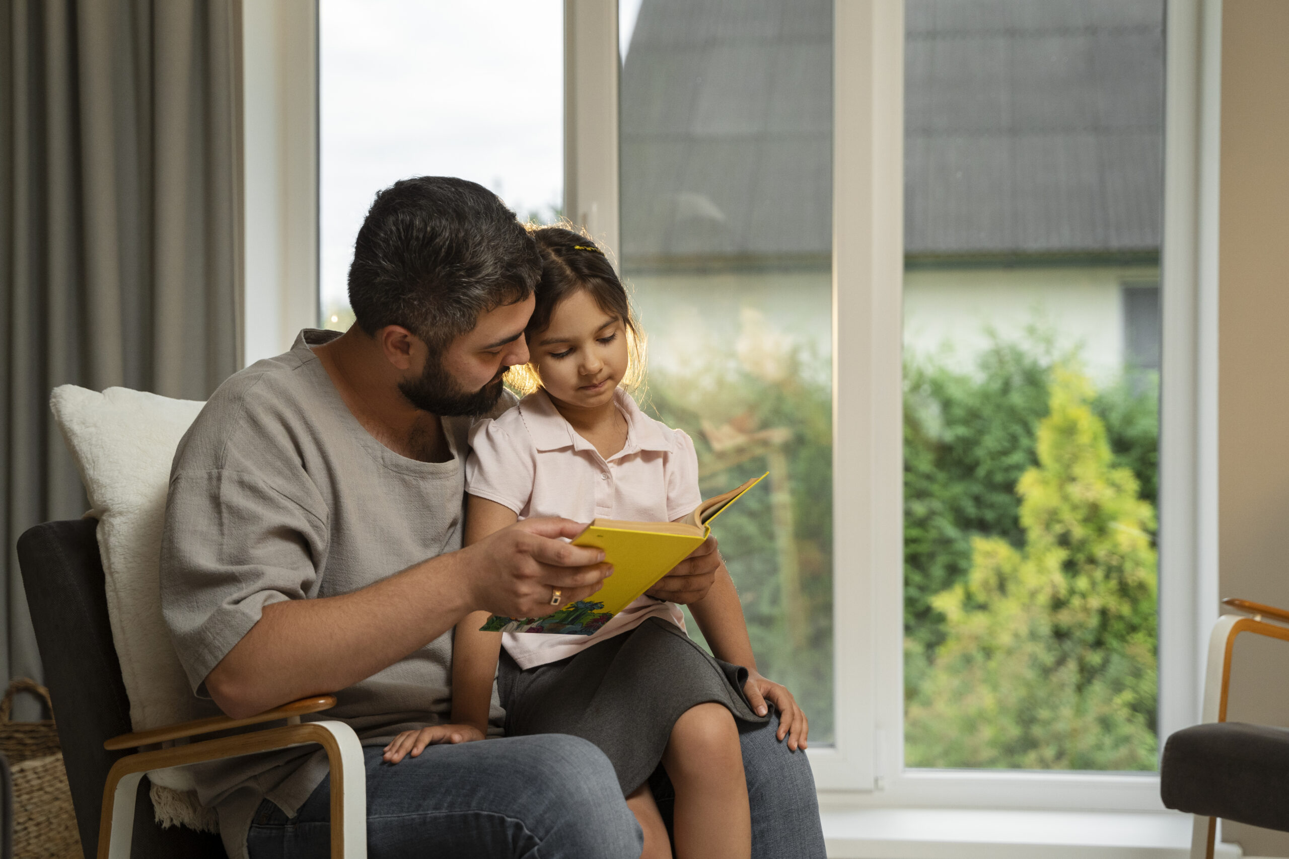 A man reading to a girl.